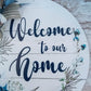 Welcome to Our Home Door Hanger, Birch Wood Round Decor, Rustic Home Accent with Navy Blue Detailing