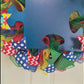 Autism Awareness Door Wreath puzzle piece; blue red yellow emerald