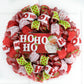 Red White and Lime Green Mesh Wreath with a wooden Ho Ho Ho sign with a Santa Face on the sign, all hanging on a white door